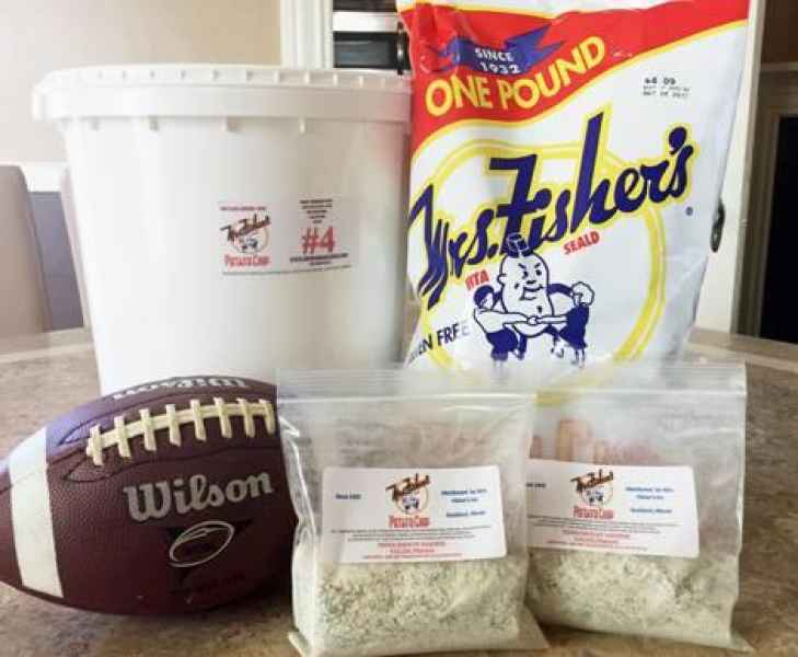 Chips, dip and football on table