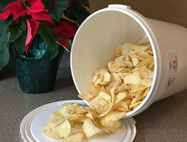 Chips spilling out of bucket on table